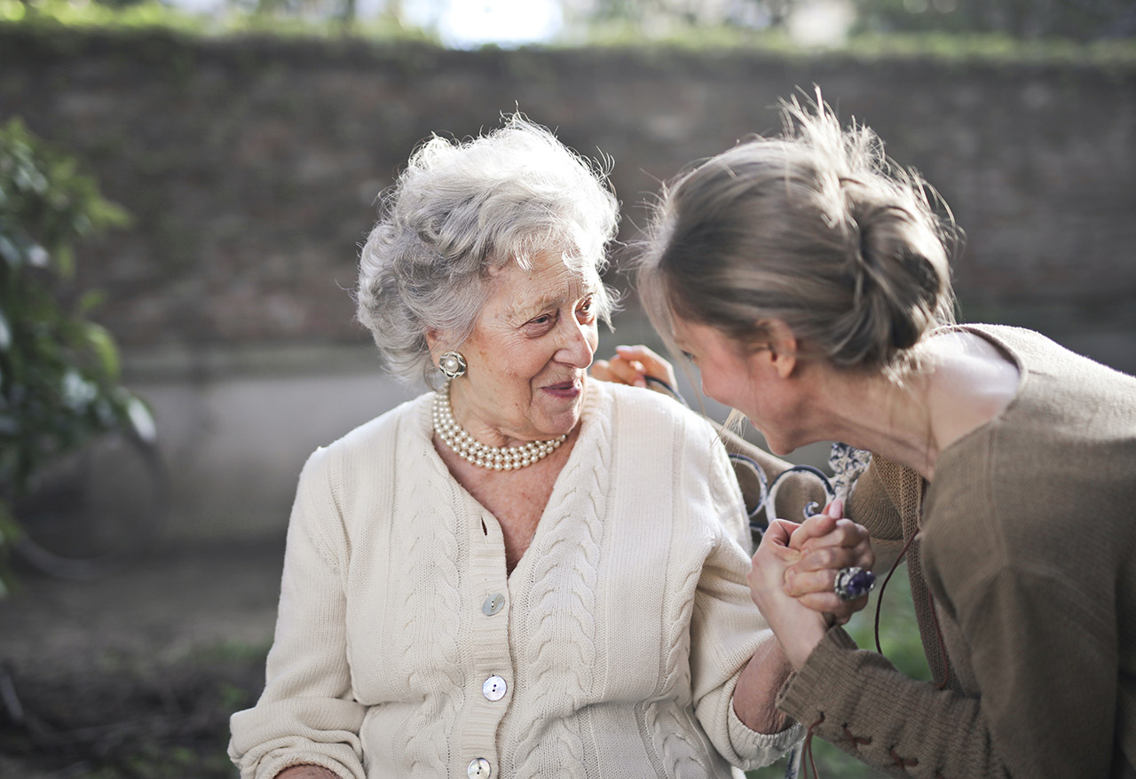 Woman in senior living talking to a friendly hospitality worker
