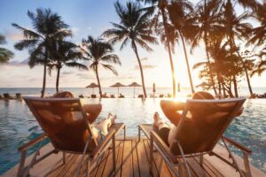 Couple Relaxing Poolside after a hotel renovation from hospitality consulting leader Hutchinson